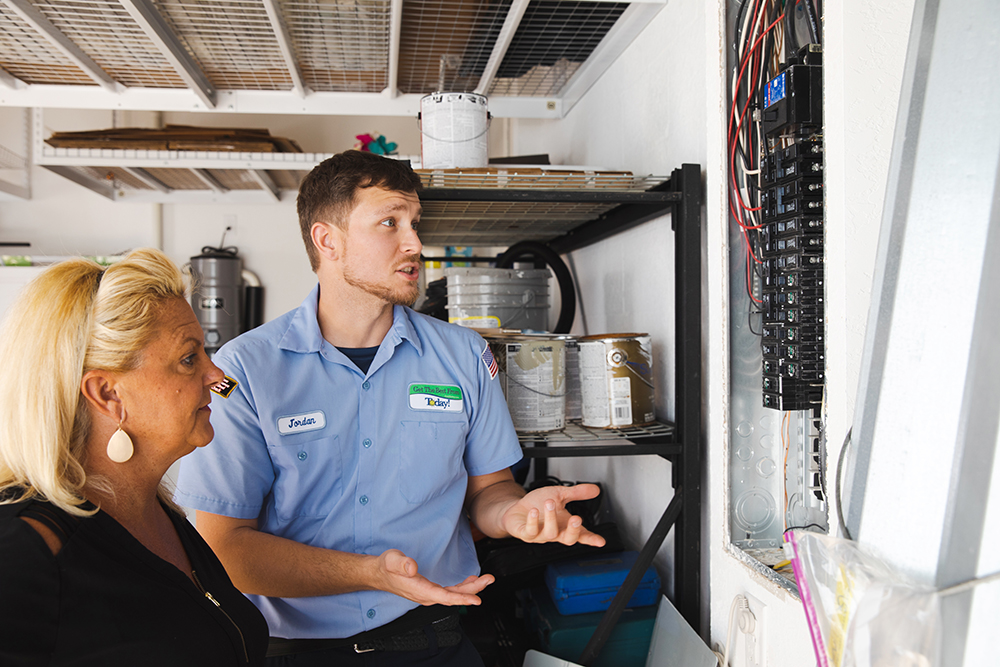 Technician explaining electrical panel setup